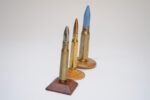 Set of Three Vintage Trench Art Bullet Casing Paperweights and Flint Lighter - Image 2